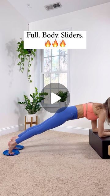 a woman is doing a push up on a box in the middle of a living room