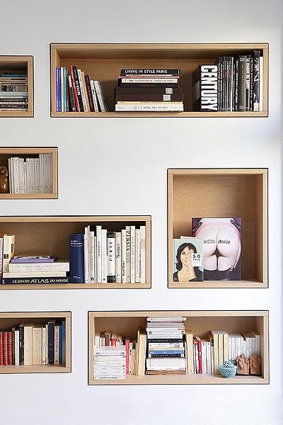 the bookshelves are lined up against the wall