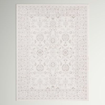 a white rug with an intricate design on it