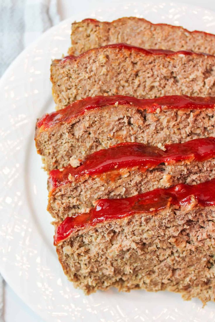 slices of meatloaf on a plate with ketchup