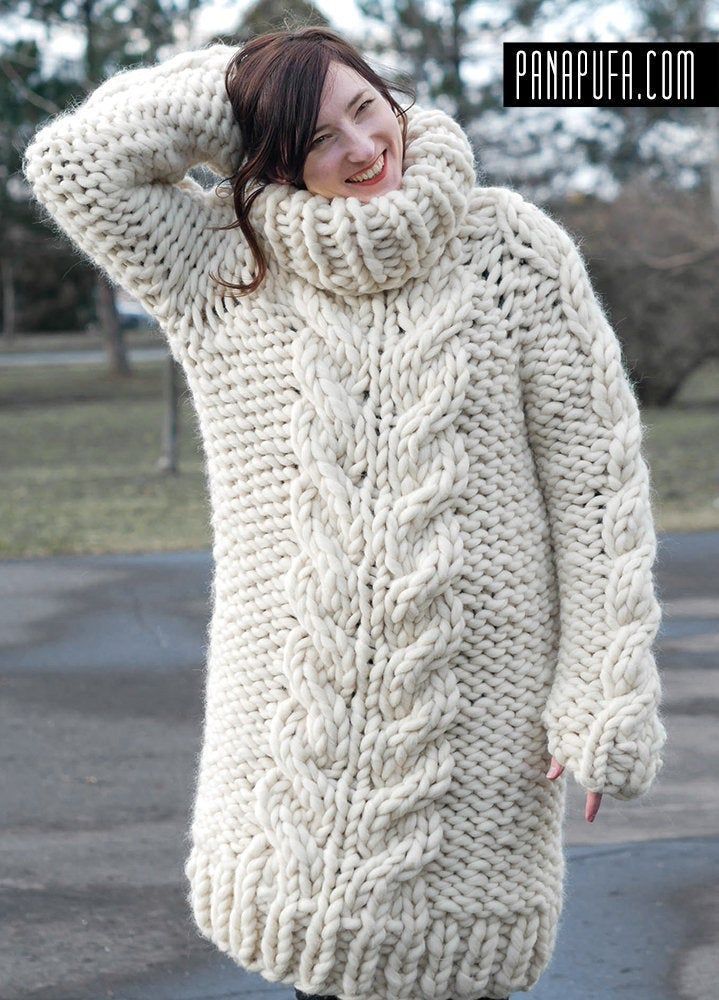 a woman wearing a white cable knit sweater