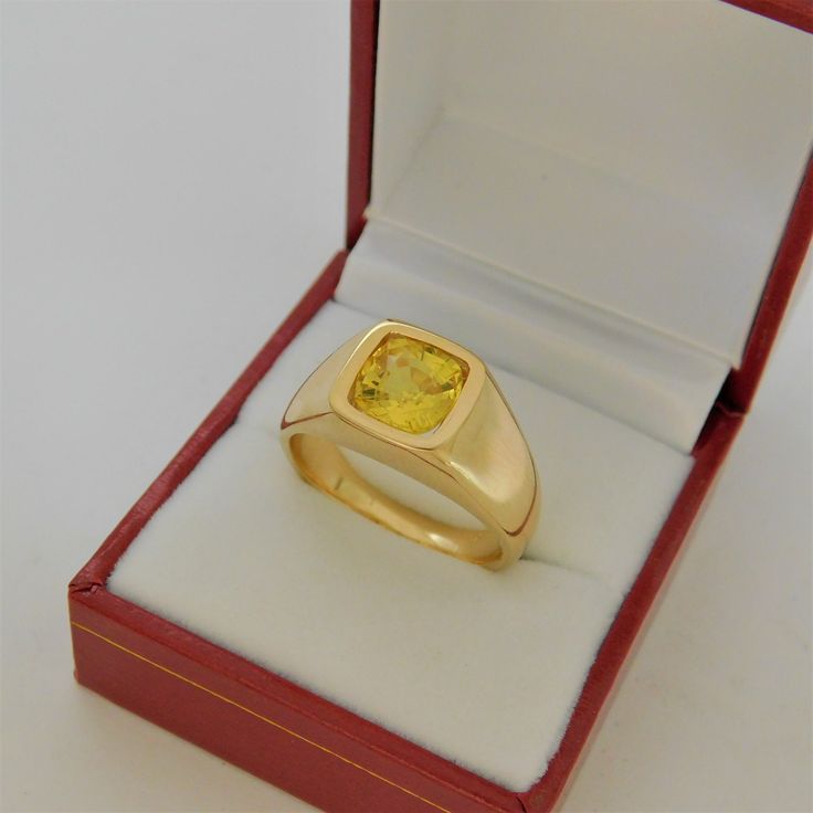 Gemstone: Yellow sapphire A gem certificate of authenticity will be provided at no charge. Treatments: Heated/Lattice Diffusion Specifications: 8.03x8.1mm, approx. 2.89 carats Color: As shown Stunning rare lemon yellow Clarity: Eye clean, almost loupe clean Cut: Cushion cut Weight: 16 grams. Ring size: 10, with all sizes available from 6.5 through 12 This is as fine and elegant a man's ring as you will ever find. The perfect blend of a fine gemstone matched up with a clean classic 14K yellow gol Gia Certified Gold Sapphire Ring In 14k Gold, Gia Certified Oval Gold Sapphire Ring, Yellow Gold Sapphire Signet Ring With Polished Finish, Modern Gold Rings Gia Certified, Gia Certified Yellow Gold Sapphire Ring, Gia Certified Gold Sapphire Ring, Formal Yellow Gold Signet Ring With Birthstone, Gold Sapphire Cushion Cut Jewelry, Classic Round Gold Gemstones