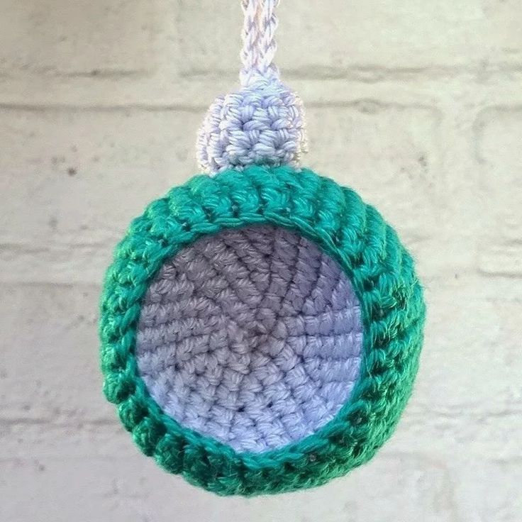 a crocheted ornament hanging from a string