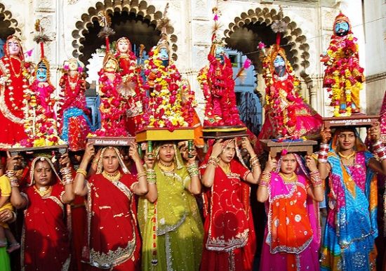 group of women in colorful saris standing next to each other