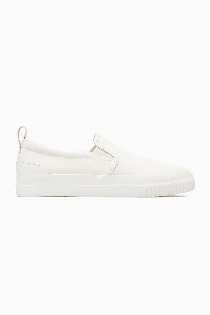 These slip-on trainers are an easy option for summer dressing – they'll go with all your casual outfits but will work equally well to pare back tailoring, too. Crafted from cotton-canvas with leather detailing, they come in versatile white and have chunky rubber soles and elasticated inserts for comfort. The leather pull tab at the back makes them easy to slip on and off. Leather binding and panellingRecycled cotton is made by converting both pre- and post-consumer fabric into fibres that are th White Canvas Slip-ons For Summer, White Slip-on Sneakers For Everyday, Cotton Slip-ons With Rubber Sole, Casual White Slip-ons With Contrast Sole, Casual White Slip-on Sneakers With Gum Sole, Comfortable Slip-on Sneakers With Gum Sole, White Slip-on Sneakers With Gum Sole, Canvas Slip-on Sneakers With Gum Sole, White Canvas Slip-on Sneakers With Rubber Sole