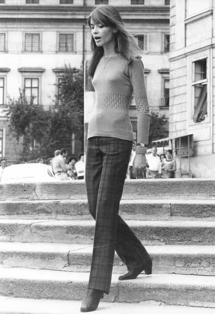 black and white photograph of woman walking down stairs