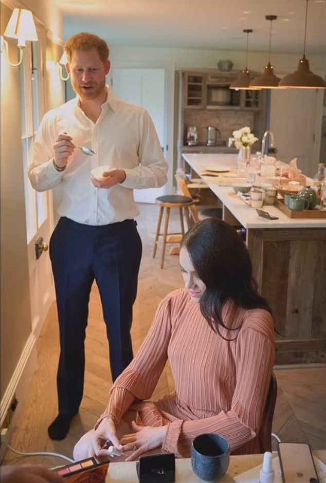 a man standing next to a woman at a table