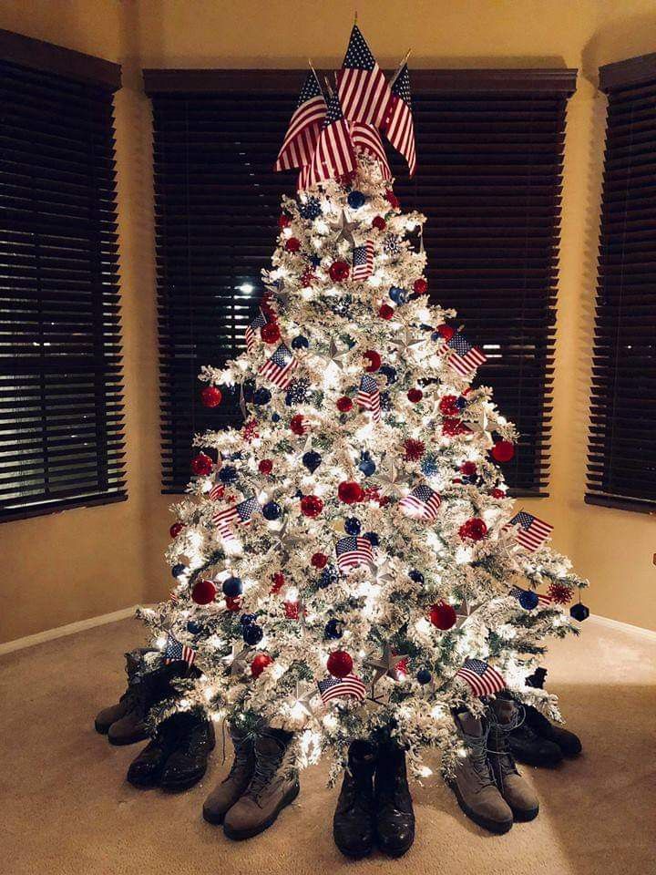 a white christmas tree with red, white and blue decorations in the center is surrounded by black shoes