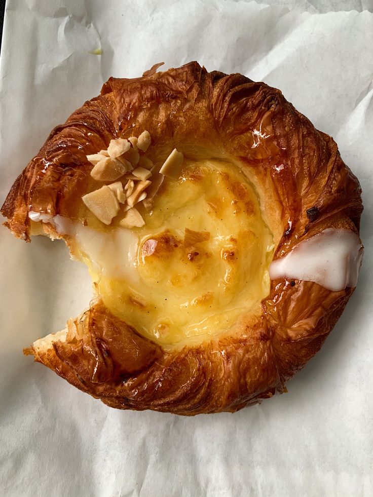 a pastry with cheese and nuts on it