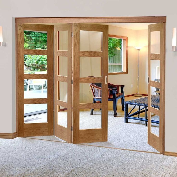 an open door leading to a living room with chairs and table in the background on carpeted flooring