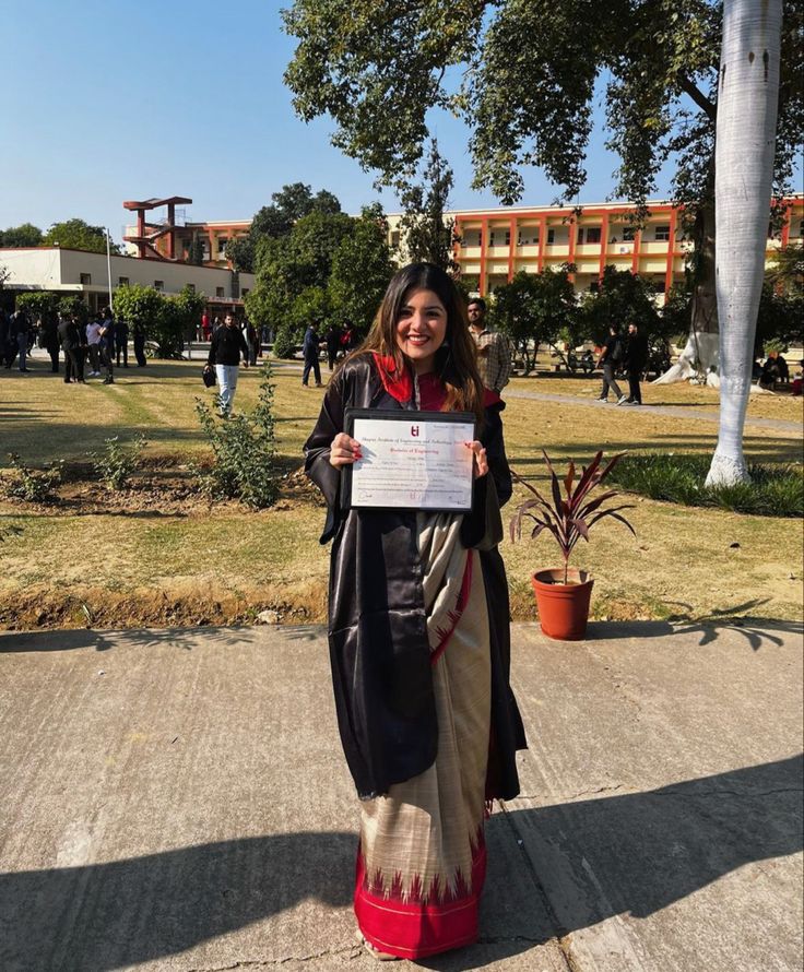 a woman standing on the sidewalk holding up a paper