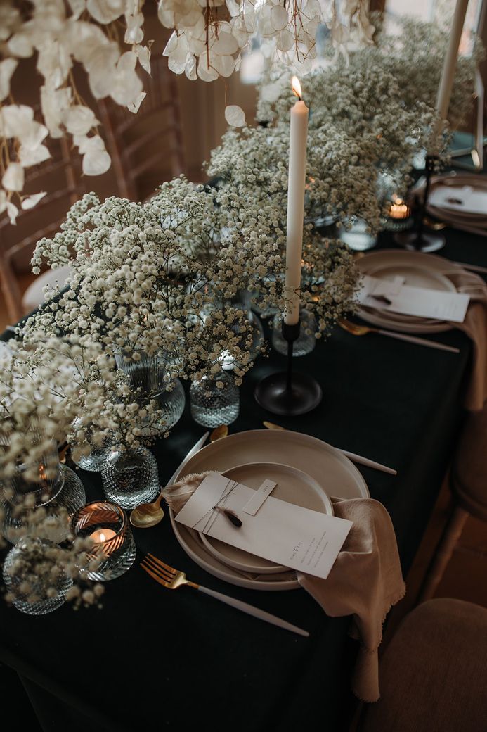 the table is set with place settings and flowers