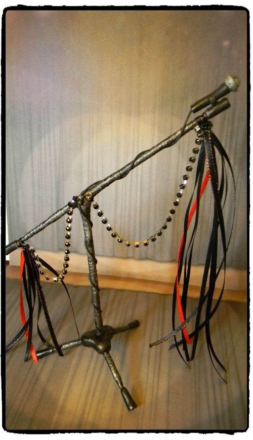 a bike frame made out of metal with beads and chains hanging from it's sides