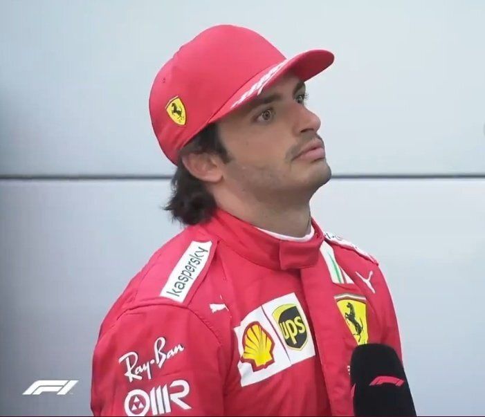 a man in a red racing suit and hat