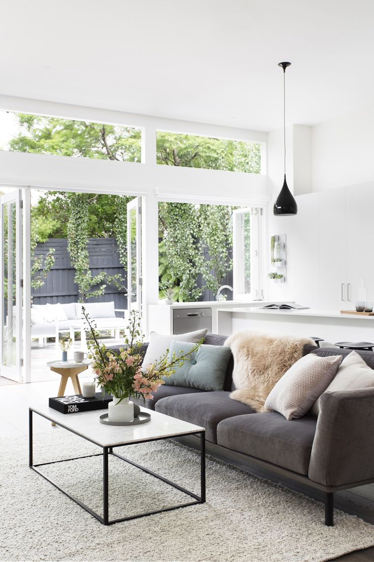 an image of a living room setting with couches and coffee table in the middle