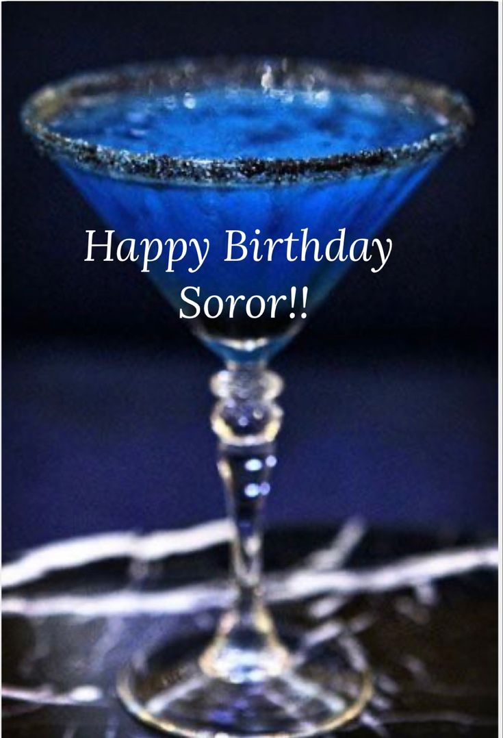 a blue martini sitting on top of a table with the words happy birthday soror