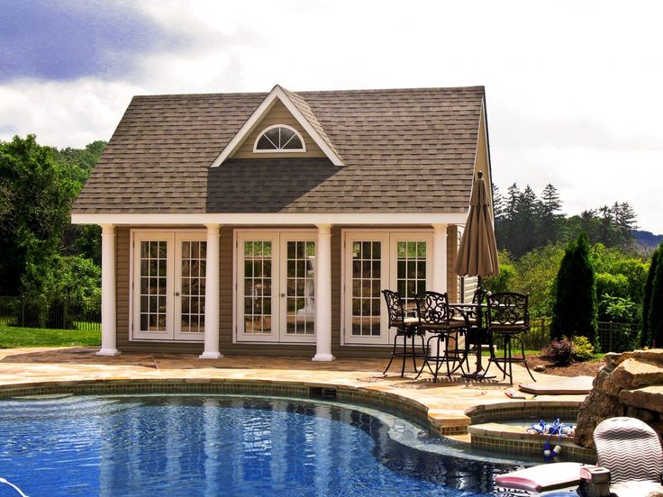 a house with a pool and patio furniture