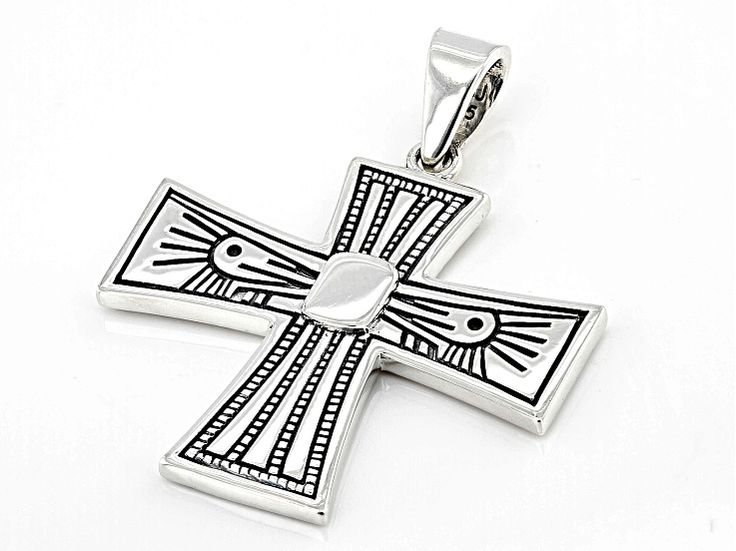 Introducing our stunning oxidized Sterling Silver Cross Pendant from Southwest Style by JTV! This exquisite piece features a captivating Cross motif, symbolizing faith and elegance. The intricate design showcases meticulous craftsmanship that will surely turn heads wherever you go. With item dimensions measuring at 1.56 inches in length and 1.28 inches in width, this pendant is the perfect addition to your jewelry collection. Complete with an eye-catching bail for easy styling versatility, this Silver Spiritual Jewelry With Artistic Design, Spiritual Silver Jewelry With Artistic Design, Silver Cross Jewelry With Symbolic Style, Silver Cross Jewelry Symbolic Style, Symbolic Silver Cross Jewelry, Antique Silver Oxidized Cross Pendant Jewelry, Silver Oxidized Cross Pendant Jewelry, Artisan Engraved Cross Pendant Jewelry, Silver Cross Jewelry With Intricate Design