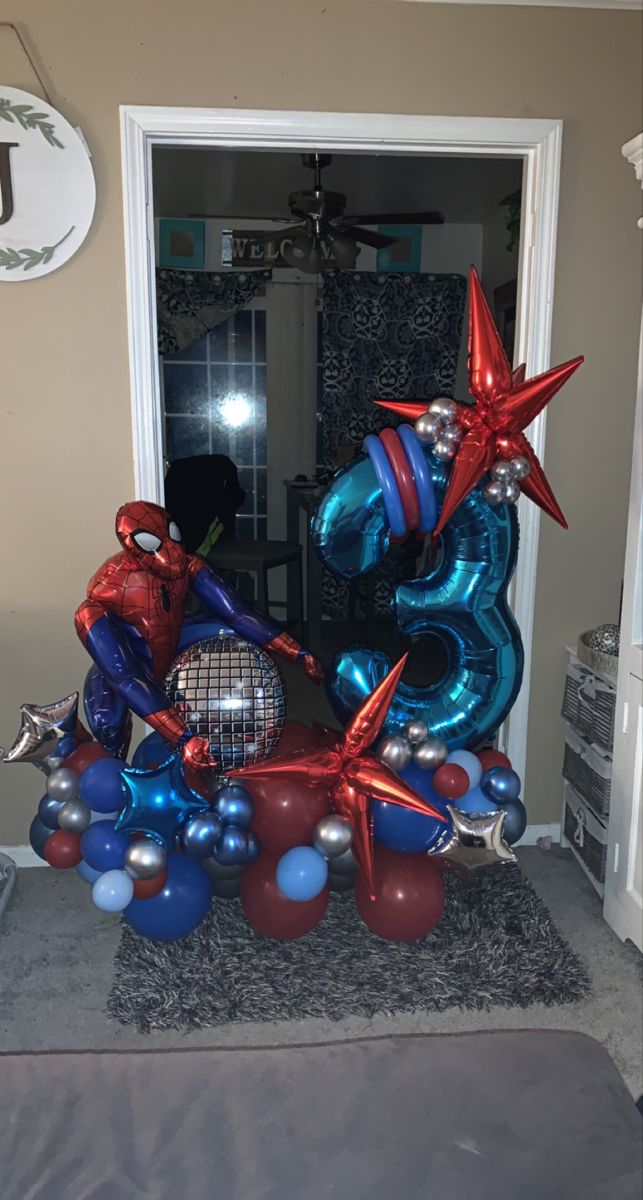 some balloons that are in the shape of stars and spiderman on top of each other