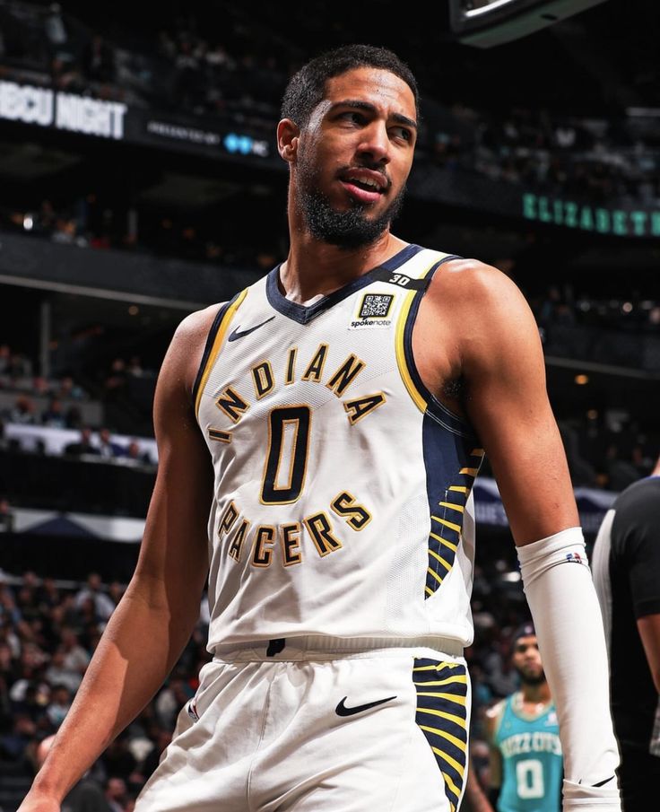 a basketball player standing in front of a crowd