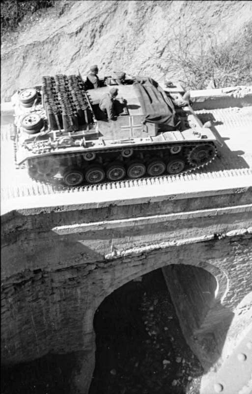 an old tank is sitting on the side of a bridge in black and white photo