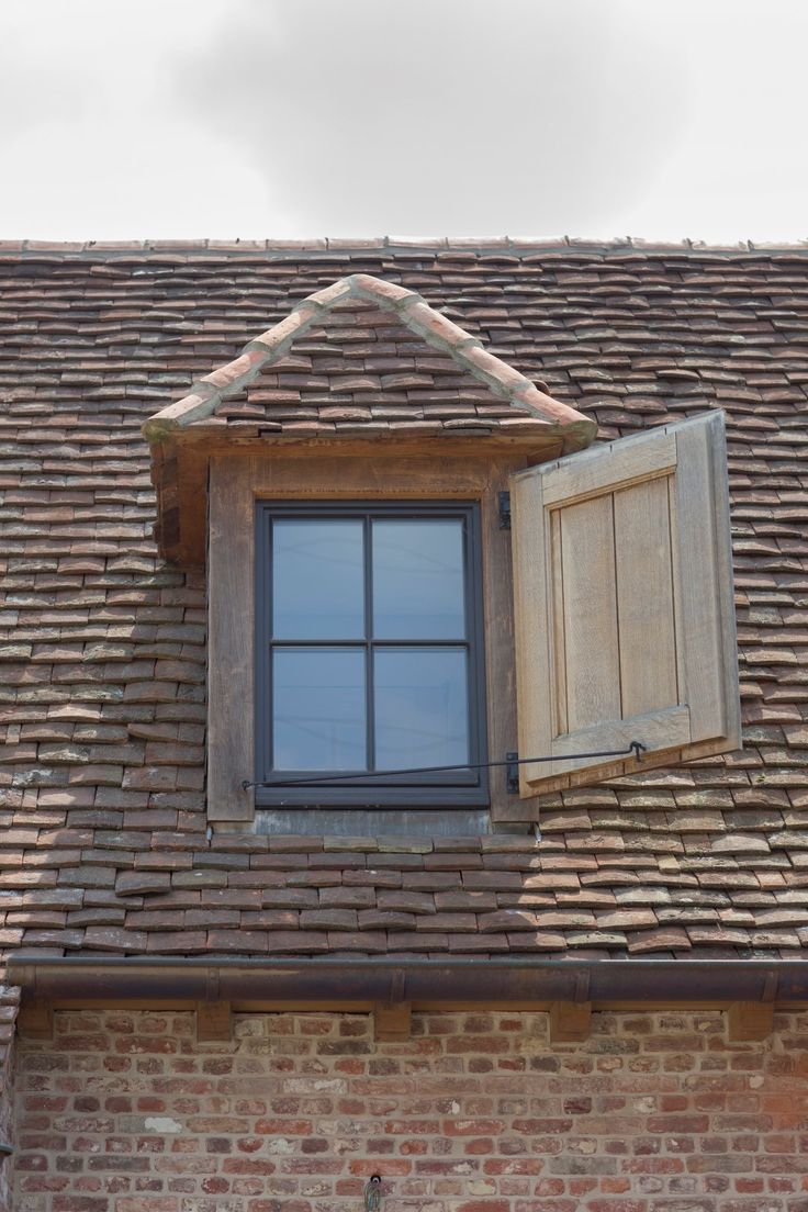 an open window on the side of a brick building