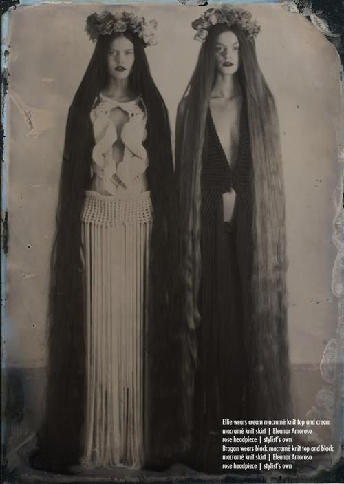 two women with long hair standing next to each other wearing headdress and veils