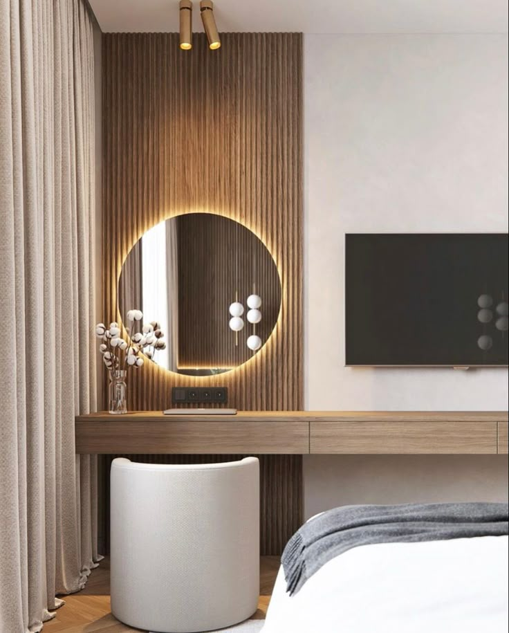 a bedroom with a round mirror on the wall next to a white stool and bed