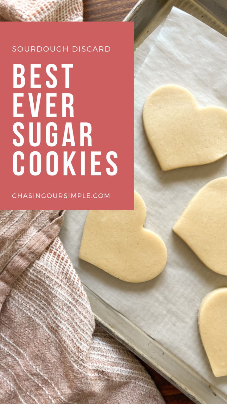 four heart shaped sugar cookies sitting on top of a cookie sheet with the words best ever sugar cookies