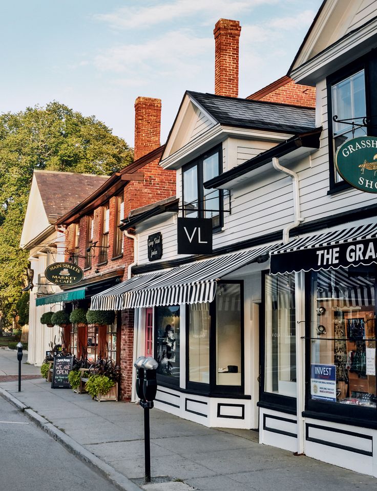 the storefronts are decorated with black and white awnings