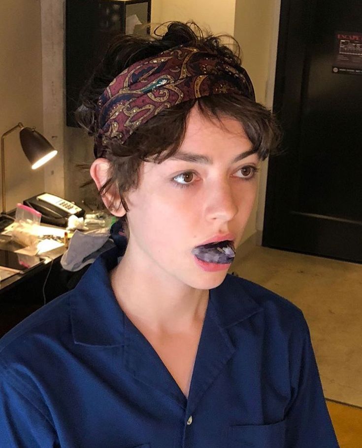 a man with a bandana on his head is eating something in front of him