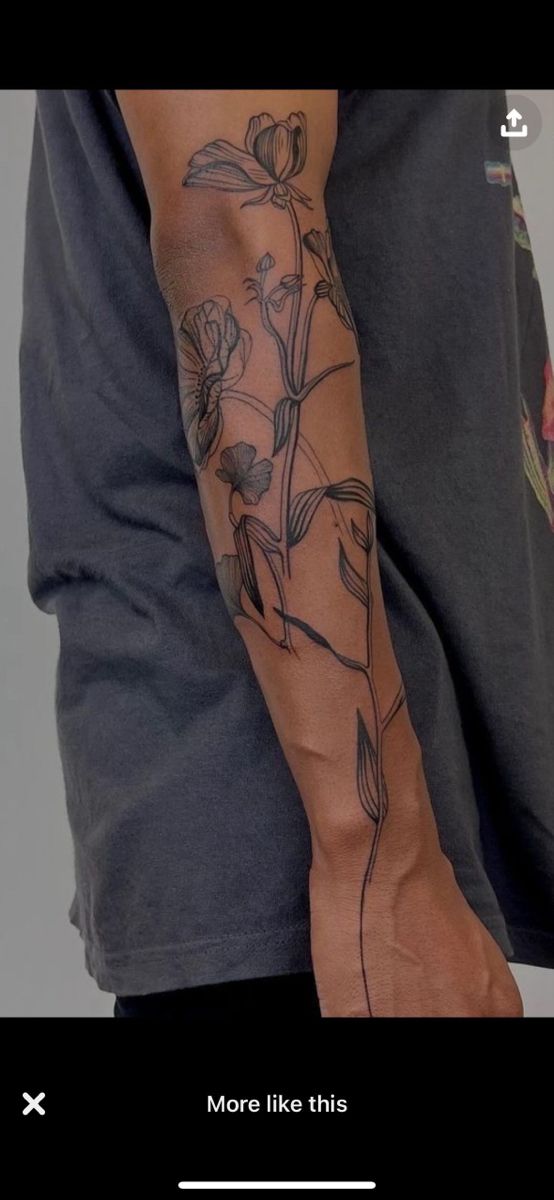 a man's arm with flowers on it and the words more like this written below