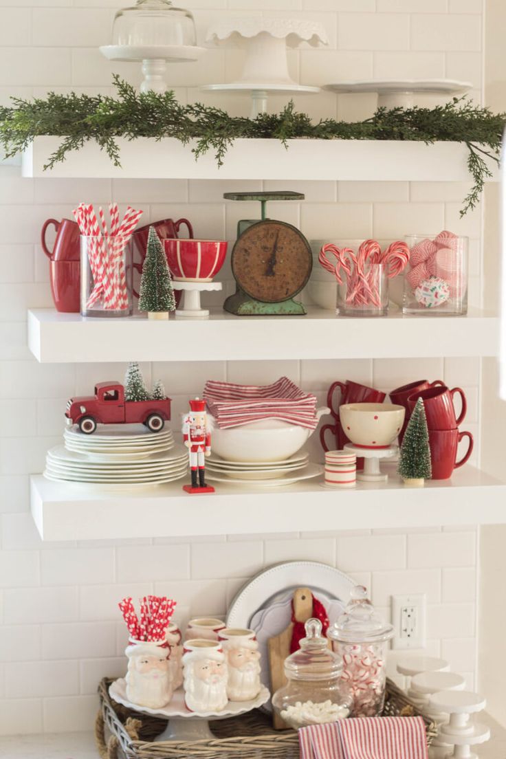 the shelves are filled with christmas dishes and decorations