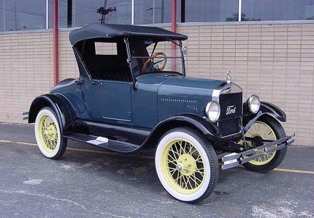 an old car parked in front of a building