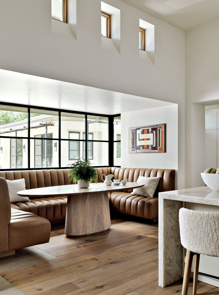 a living room filled with furniture and windows