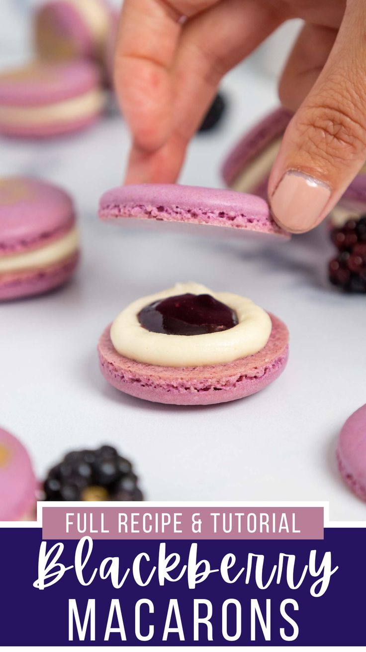 a person picking up some cookies from the table with berries and blueberries on it