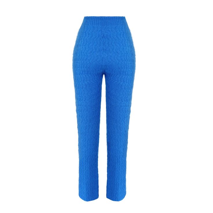 These knitted pants are your perfect companion for the fresher days and just make you feel extravagant and super cozy at the same time.  There is some extra elastic support in the waistband rib, so the pants stay snug around your waist.  You can complete the look with the CCY currency Mohair Zigzag Bubble Sweater.   They are made from high quality Italian yarn in a small family-run knitting facility in Italy with a special zigzag relief pattern that has been developed by CCY currency for this collection.   It comes in either electric blue or a dark peacock green melange.  The fit is tight around the hips and legs and opens up a bit towards the ankles. 50% Superkid Mohair Wool 32% Polyamide 18% Merino Wool  Made in Italy   Hand wash cold or dry clean Dry flat No tumble Air out rather than w Spring Blue Knit Bottoms, Blue Knit Bottoms For Spring, Stretch Knit High-waisted Pants, Bubble Sweater, Knitted Pants, Brand Magazine, Artisan Gift, Peacock Green, Mohair Wool