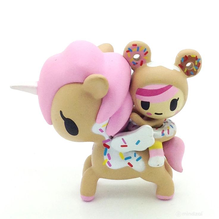 a toy figurine with pink hair and horns holding an infant doll in her arms