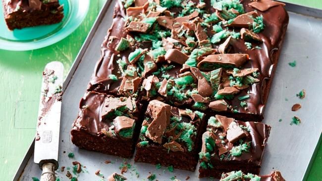 chocolate cake with green frosting on a tray