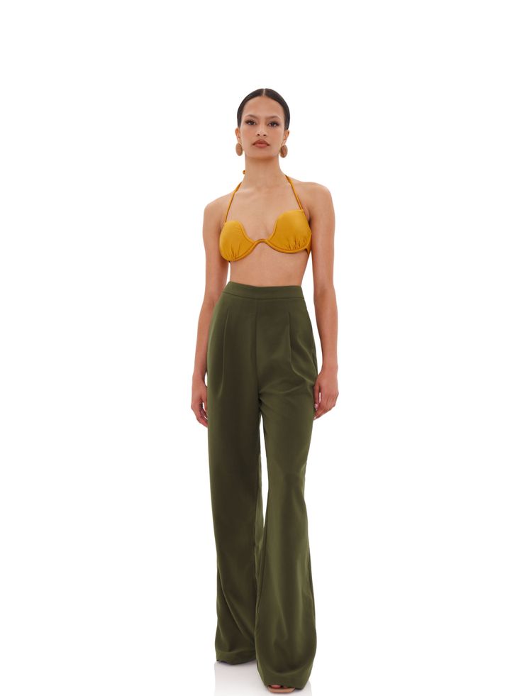 Andrea Iyamah masters classic tailoring with these smart pants. Made from smooth stretch fabric in an olive green hue, they offer the perfect blend of comfort and style in an elongating silhouette. The trousers are sewn with darts at the front and fall to a timeless bootcut hem. Pair yours with heels or ankle boots.- Reinforced waistband, back welt pockets, back invisible zipper closure with hook and eye- Polyester, spandex- Styled with the Varu Top in the photos- Ships from the United States Luxury Tailored Pants For Fall, Luxury Tailored Green Pants, Luxury Classic Green Pants, Luxury Trousers With Zipper Closure, Luxury Olive Trousers, Luxury Fall Trouser Sets, Luxury Green Dress Pants With Pockets, Luxury Tailored Dress Pants With Welt Pockets, Luxury Tailored Dress Pants For Fall