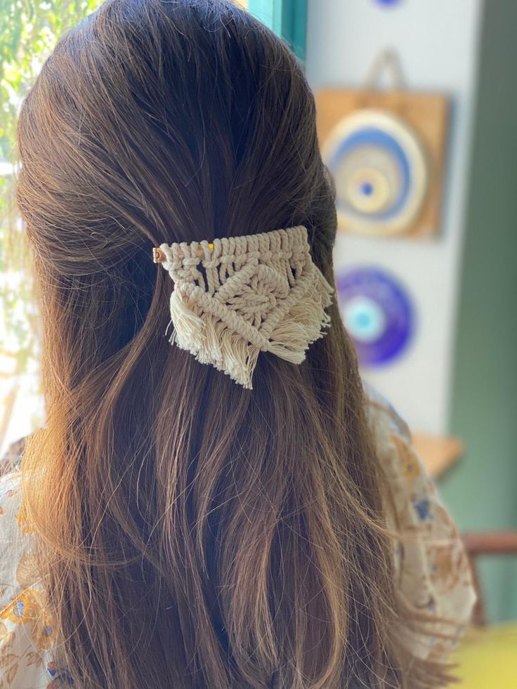 the back of a woman's head wearing a crochet hair clip