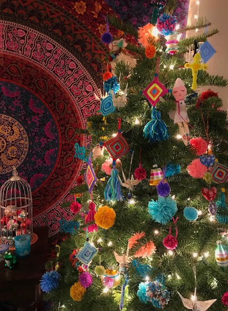 a brightly colored christmas tree with ornaments on it