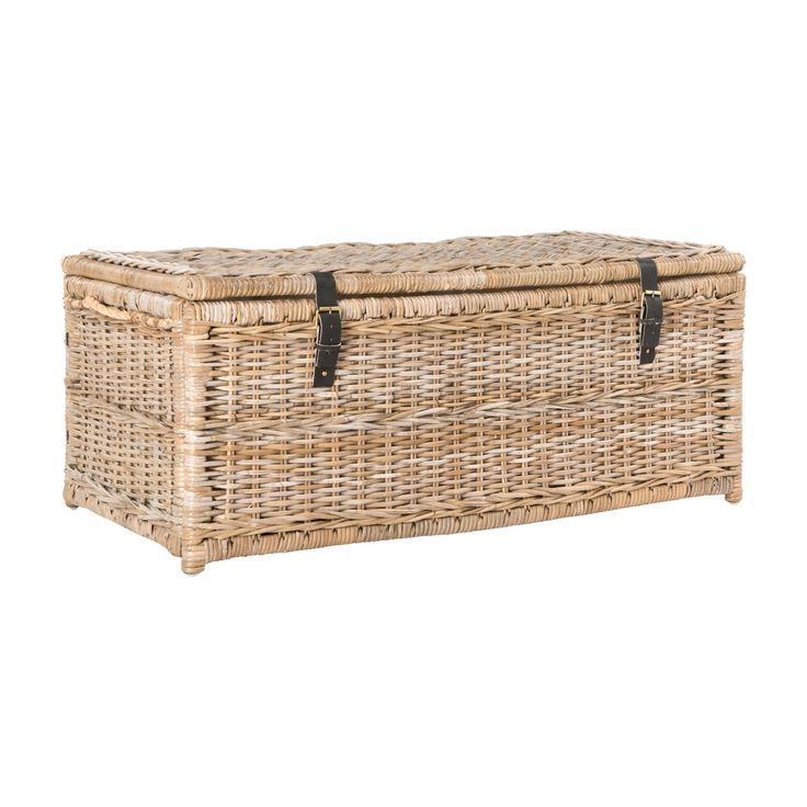 an empty wicker box with leather straps on the top and bottom, sitting against a white background