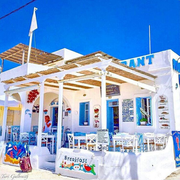 a white building with blue doors and windows