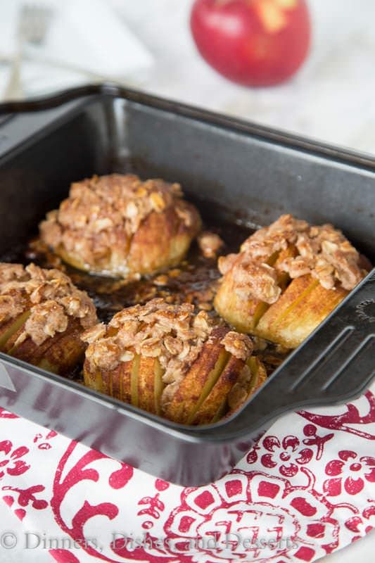 baked apples in a baking pan on a red and white tablecloth