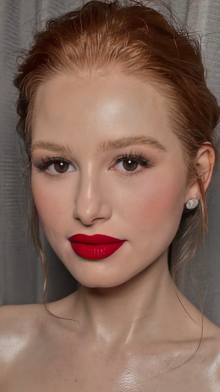 a woman with red lipstick on her face