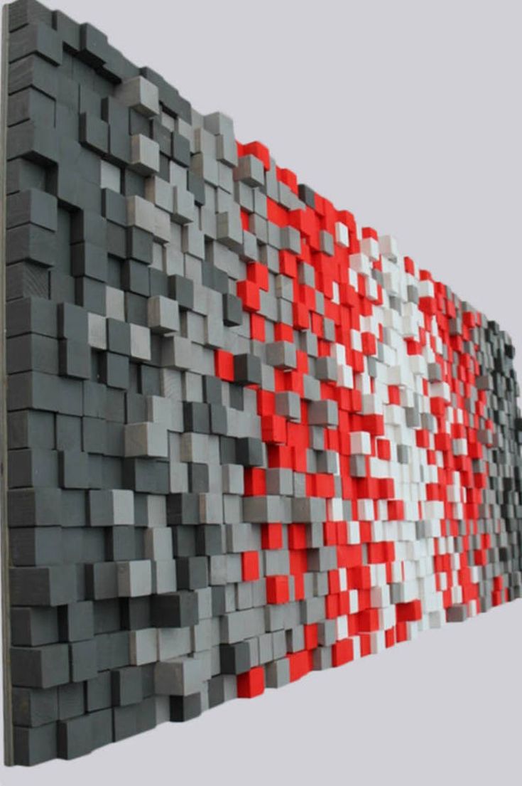 a wall made out of blocks with red and white squares on it's sides