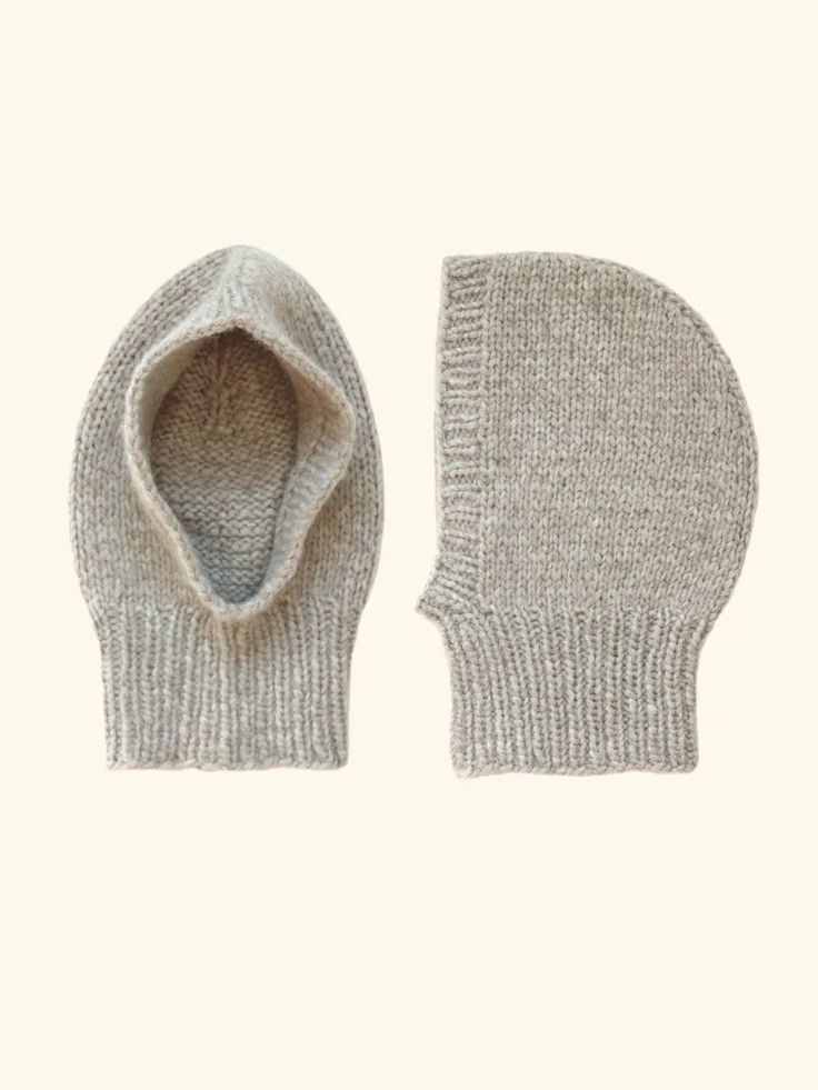 a pair of mitts sitting on top of a white surface