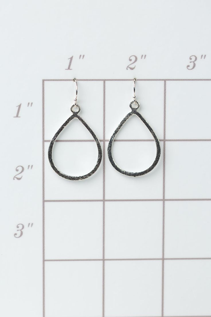 The brushed silver findings in a simple teardrop design. They are created with brushed silver plated brass, and dangle at approximately 1.5" from sterling silver ear wires. Silver Plated Brass (nickel and lead-safe) 1.5", with sterling silver ear wires We hand select our natural materials, thus there may be slight variations in color and/or size that will not detract from the overall aesthetic Our unique handcrafted designer jewelry for women is made in America, each design created individually Hypoallergenic Metal Teardrop Pendant Jewelry, Hypoallergenic Teardrop Pendant Jewelry, Everyday Metal Teardrop Drop Earrings, Everyday Metal Teardrop Earrings, Silver Metal Teardrop Earrings For Everyday, Modern Nickel-free Dangle Teardrop Earrings, Silver Teardrop Everyday Earrings, Everyday Nickel-free Teardrop Metal Earrings, Everyday Silver Teardrop Metal Earrings