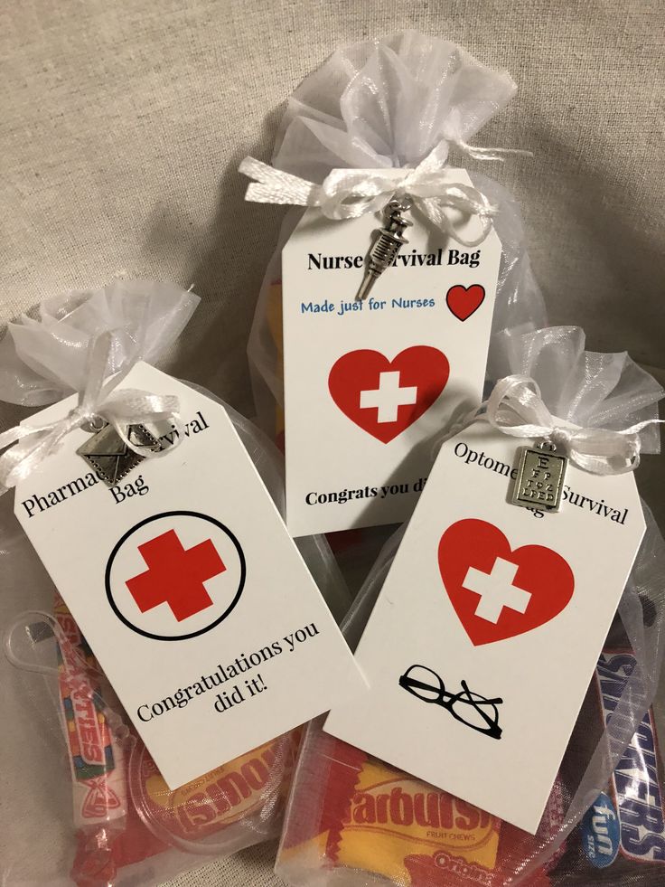 three tags with medical symbols on them in plastic bags